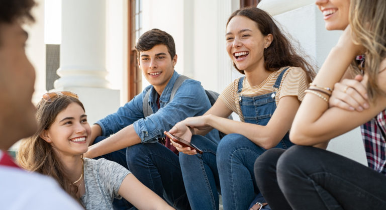 Teenager friends sitting together and laughing