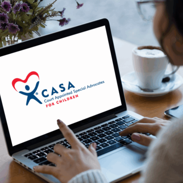 computer with casa logo and person looking at computer