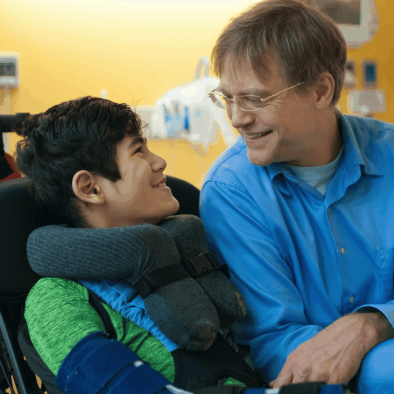 boy in wheelchair smiling at man