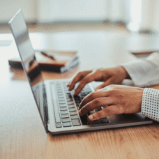 person typing on laptop