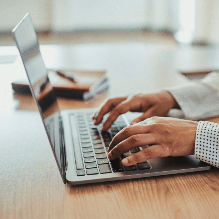 person typing on laptop
