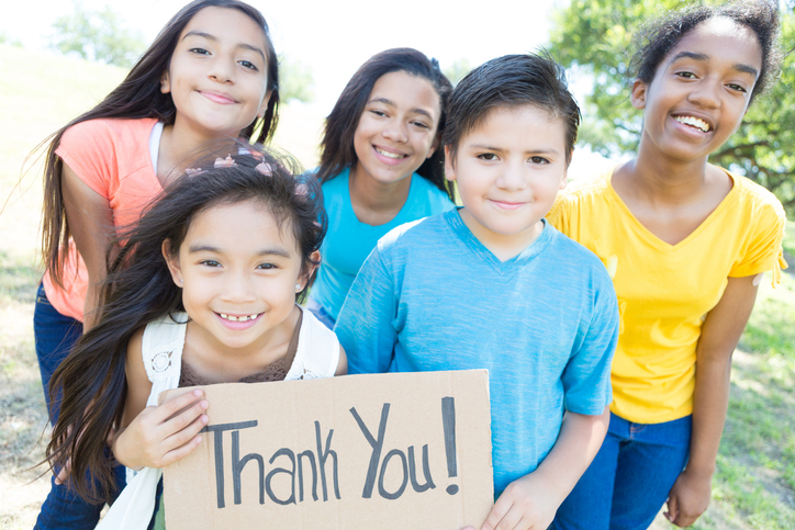 group of kids holding thank you sign
