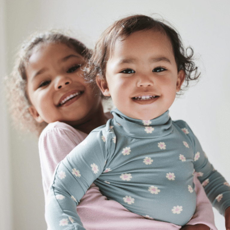 two young siblings smiling