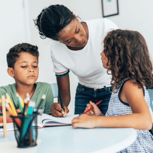 woman coloring with two children