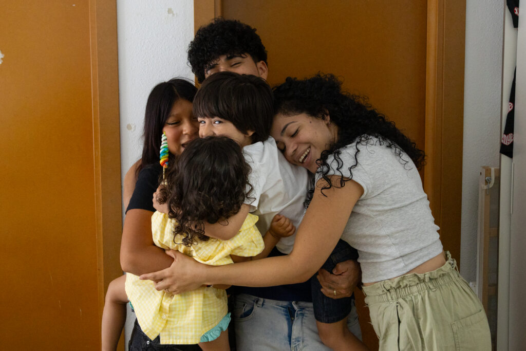 affectionate family sharing a warm embrace indoors 2026 03 20 03 47 54 utc